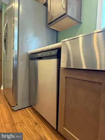 a kitchen with a sink a refrigerator and a window