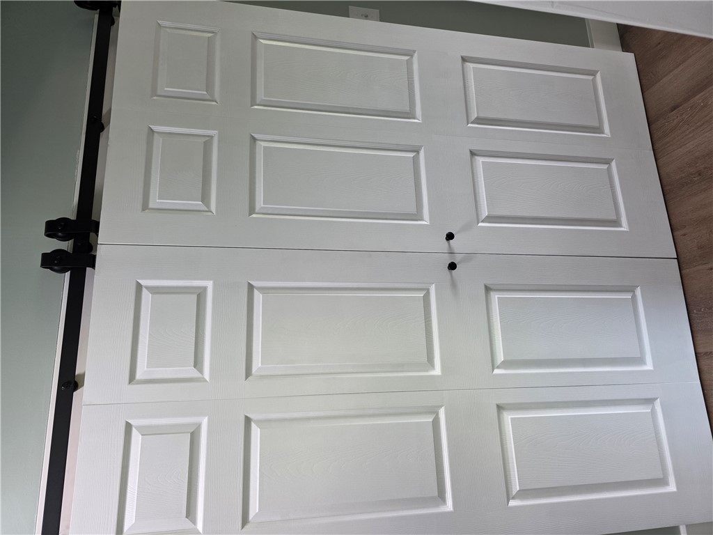 112 Simmons Street Anderson, SC 29625 - Photo 22 of 26 These white paneled barn doors offer a stylish, space-saving solution for any interior opening.