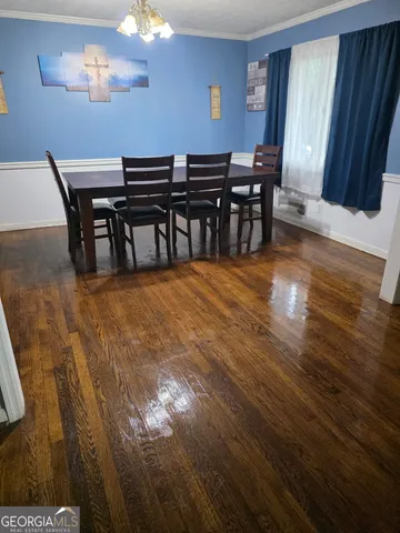 a view of a room with furniture and wooden floor