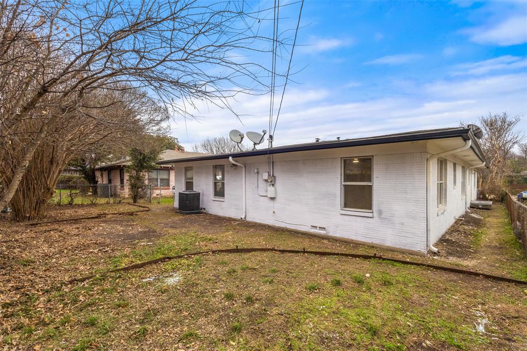 1917 South Vernon Avenue Dallas, TX 75224 - Photo 28 of 28 Exterior of the property featuring white brick siding, a dark roofline, and multiple windows