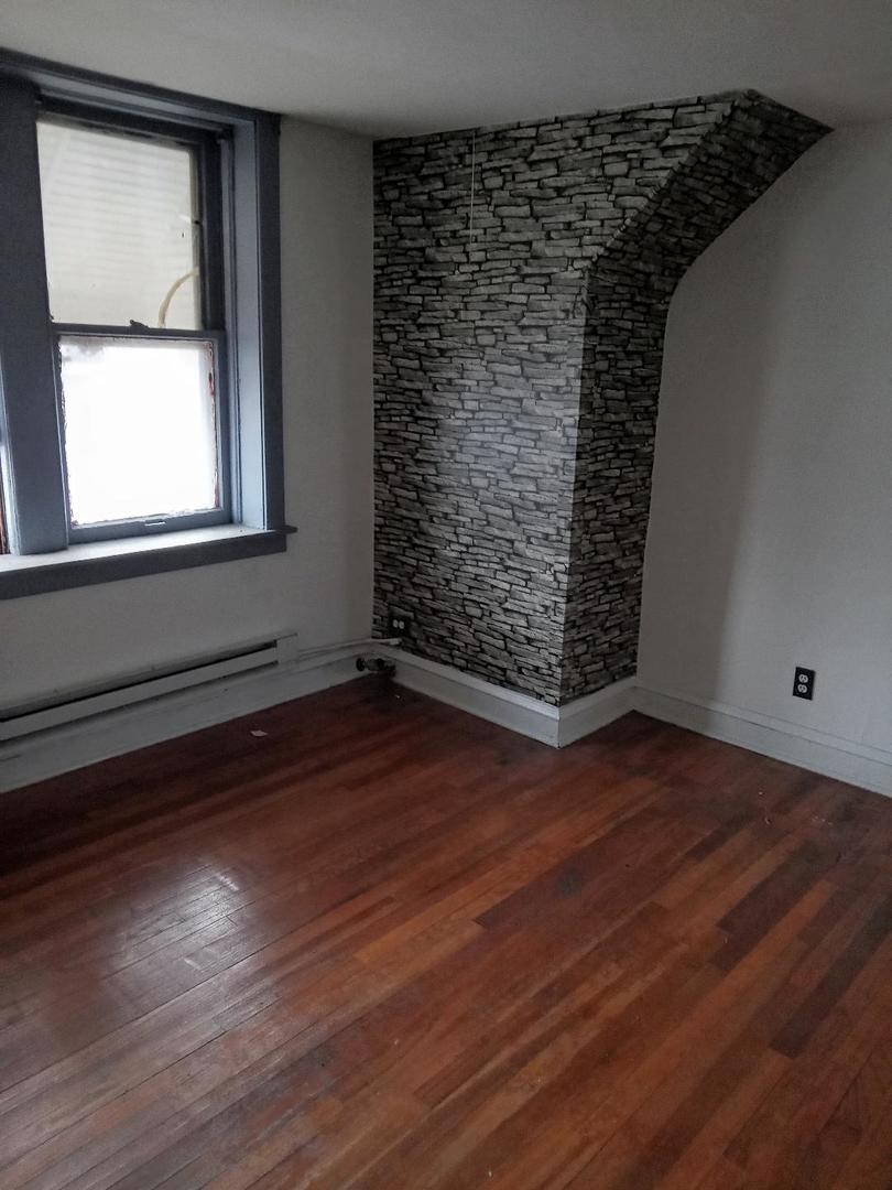 8446 South May Street Chicago, IL 60620 - Photo 4 of 6 a view of empty room with wooden floor