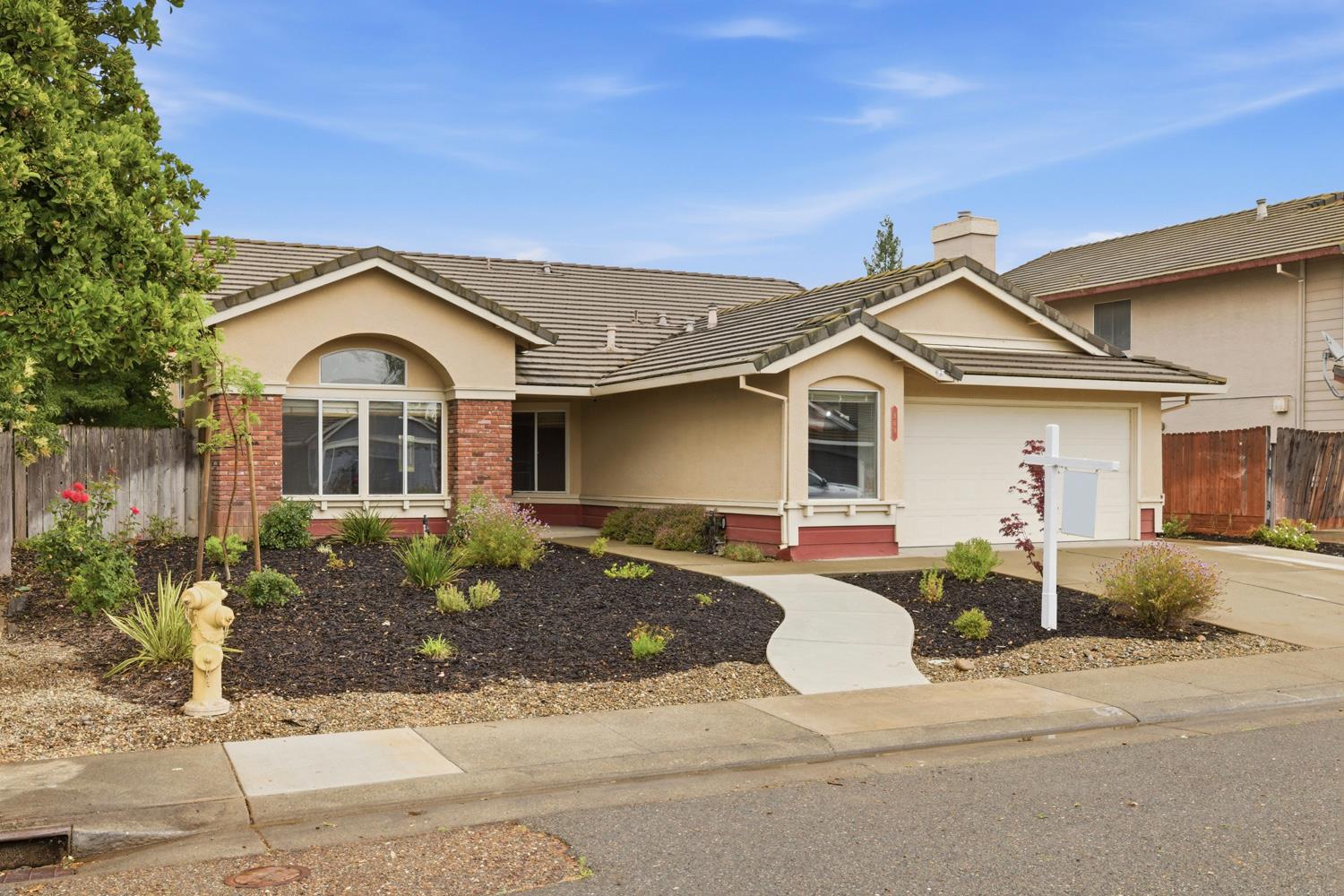969 Colson Way Galt, CA 95632 - Photo 2 of 38 a front view of a house with a garden