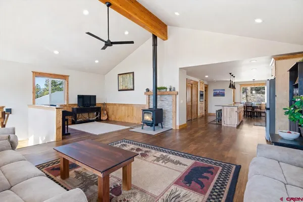 a kitchen with stainless steel appliances granite countertop a stove a sink and a wooden floors