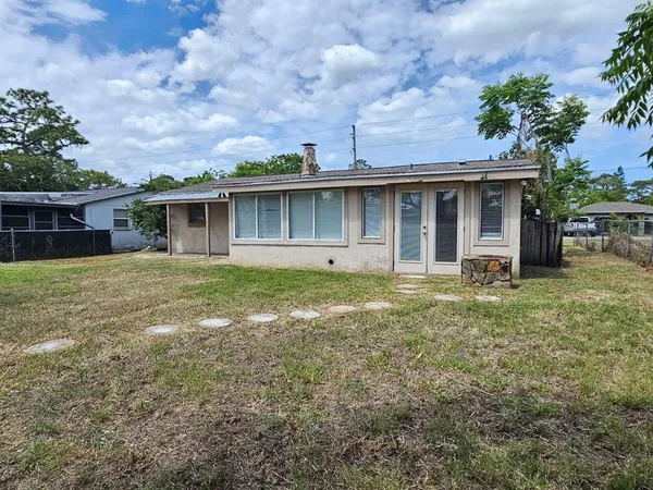 a view of a house with yard and sitting area