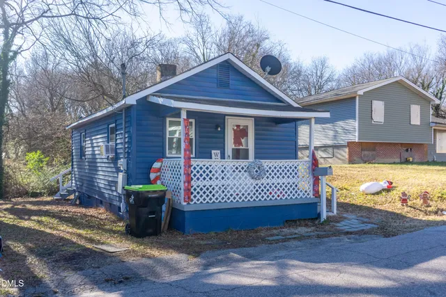 a view of a house with a yard patio and a yard