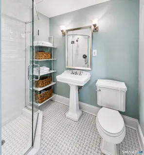 a bathroom with a sink a toilet and a mirror