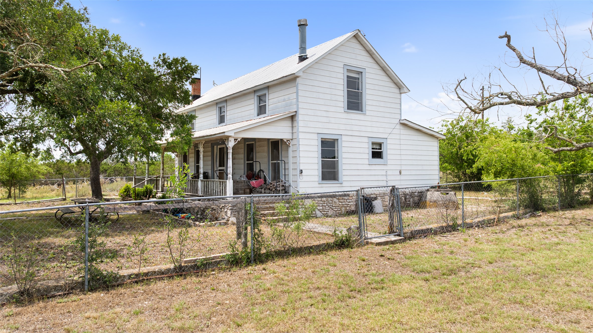 65 Miles Lane Harper, TX 78631 - Photo 3 of 27 a view of a house with a yard and sitting area