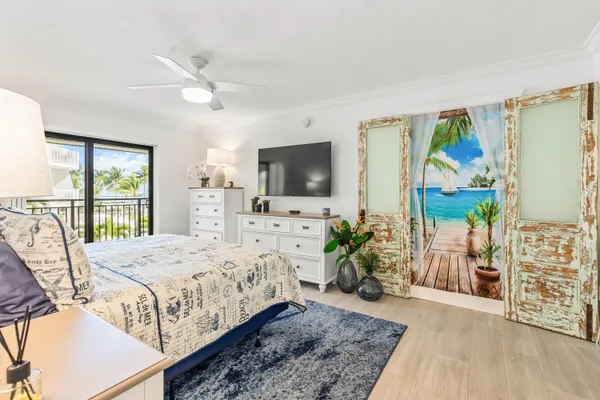 a bedroom that has a bed and a table in it