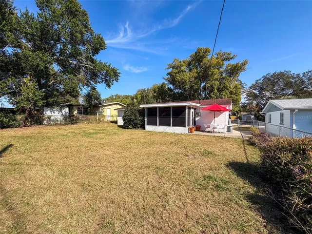 a yellow house with trees in front of it