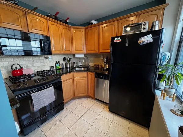 a kitchen with stainless steel appliances granite countertop a refrigerator and a stove