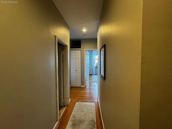 a view of hallway with wooden floor