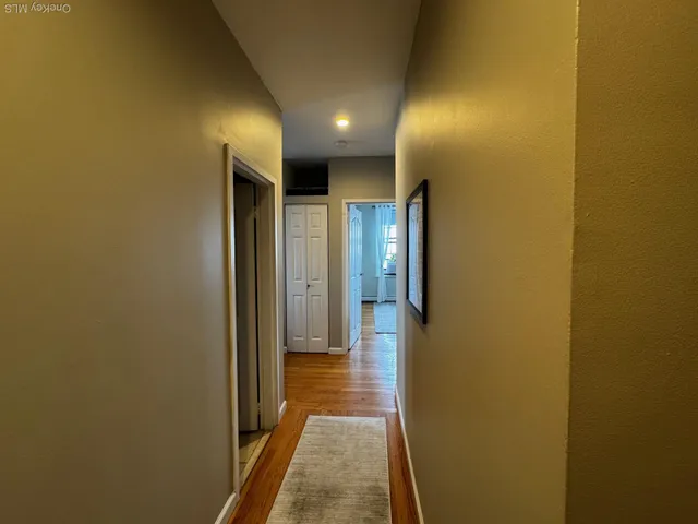 a view of hallway with wooden floor