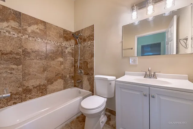 a bathroom with a sink toilet vanity and tub