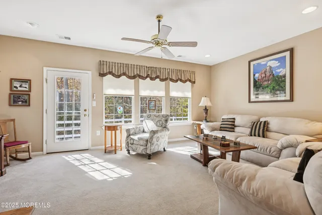 an aerial view of a house with a yard and large trees
