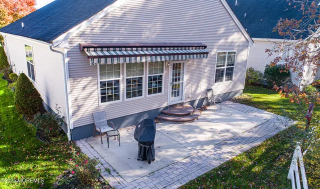 a view of a house with backyard and sitting area