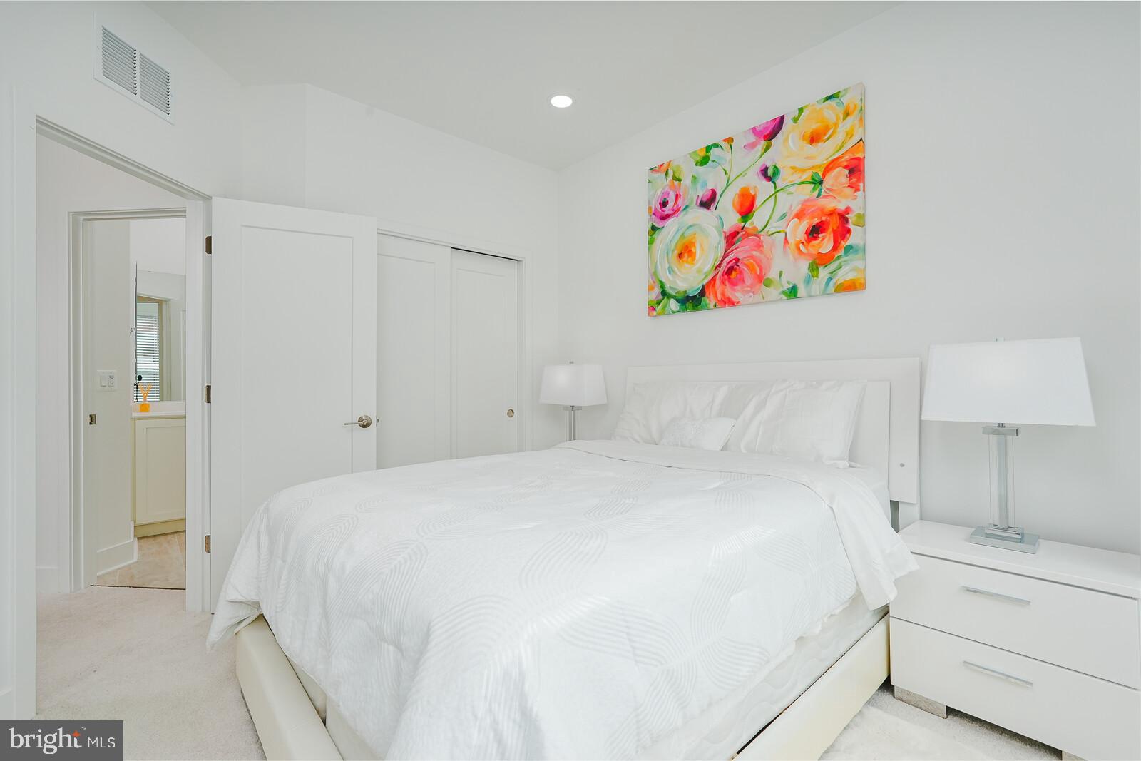 5345 Zenith Overlook Bethesda, MD 20816 - Photo 40 of 53 a bedroom with a bed and a painting on the wall