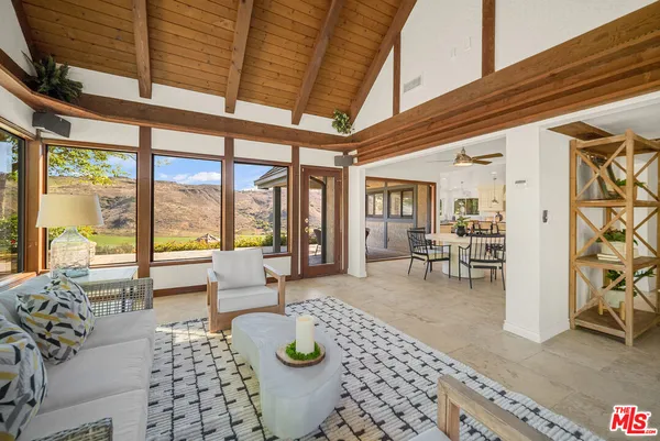 a view of a dining room and livingroom with furniture