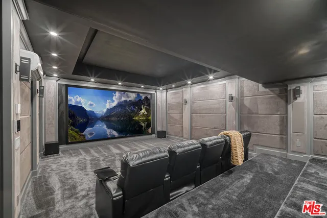 a living room with furniture and a kitchen area