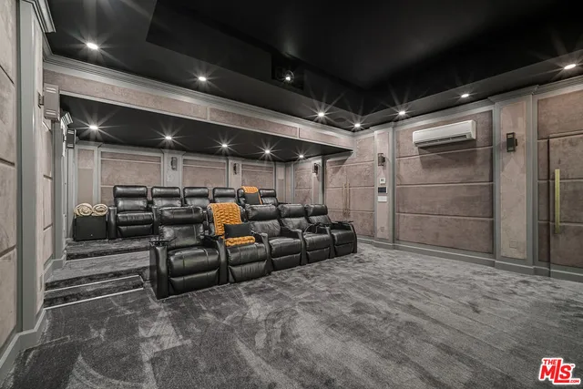 a spacious bedroom with a bed a table and a dresser next to a window