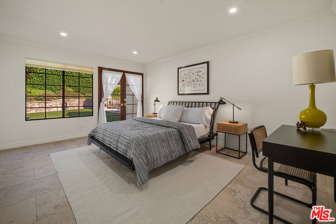 11875 Pradera Road Santa Rosa Valley, CA 93012 - Photo 27 of 35 a spacious bedroom with a bed a table and a dresser next to a window