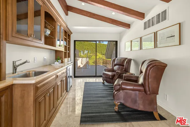 a view of a patio with furniture and a yard