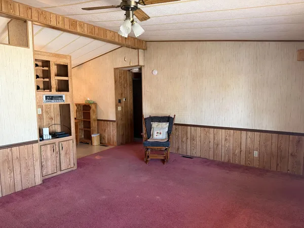 a hallway with a view of dining room and wooden floor