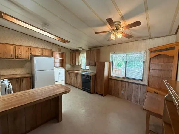 a kitchen with stainless steel appliances a stove a sink and a refrigerator