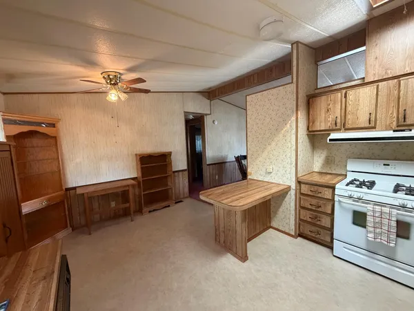 a kitchen with refrigerator and cabinets