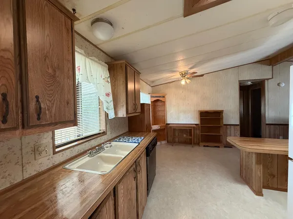 a kitchen with refrigerator and window