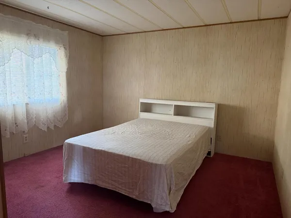 a bed sitting in a room next to a window