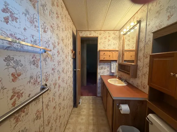 an empty room with a fireplace and window
