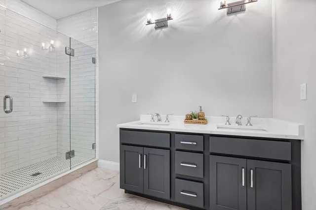 a bathroom with a sink double vanity and shower