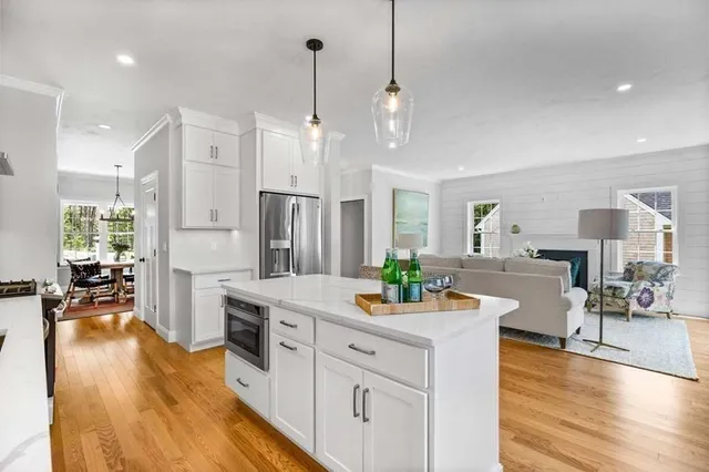 a view of a kitchen and dining room wooden floor windows