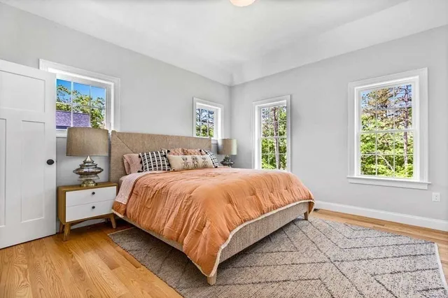a bed sitting in a bedroom next to a window