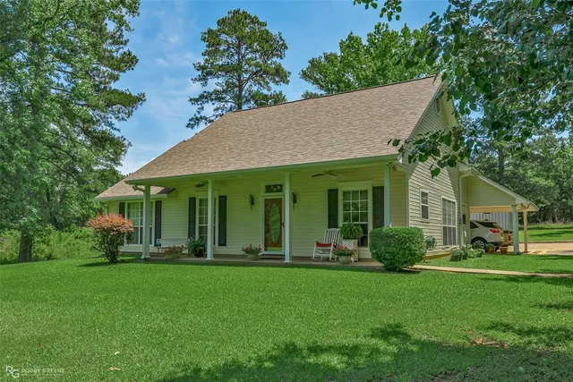 a view of a house with garden and yard
