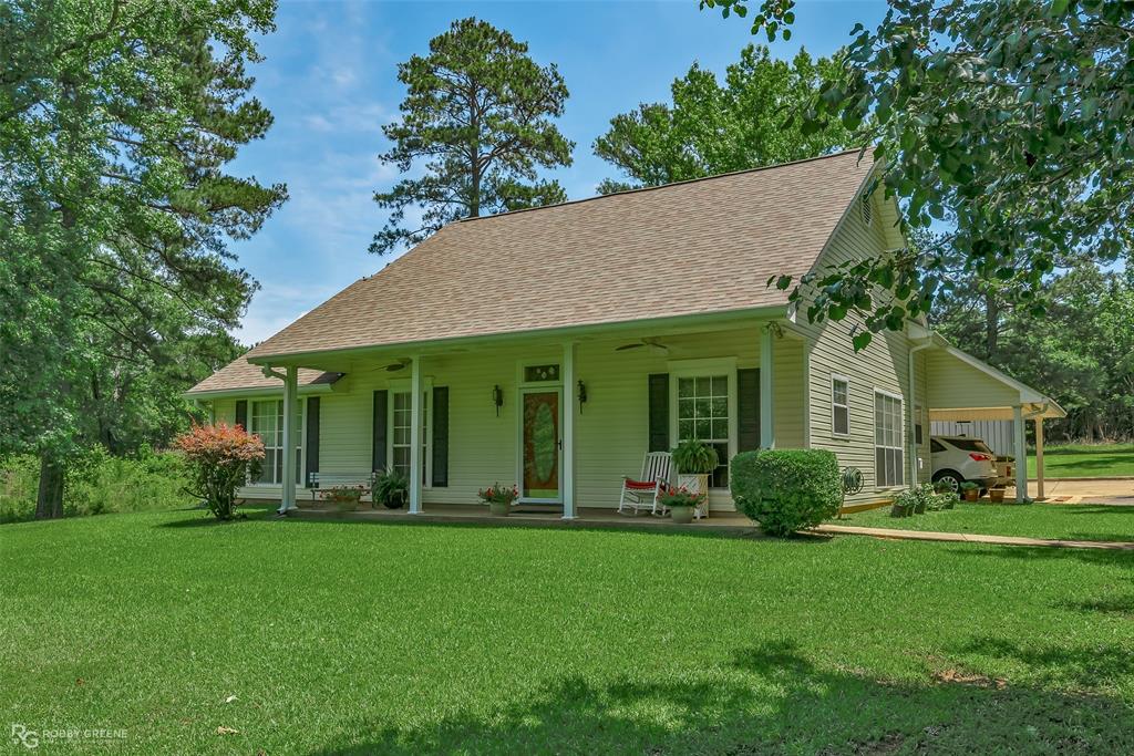 a view of a house with garden and yard