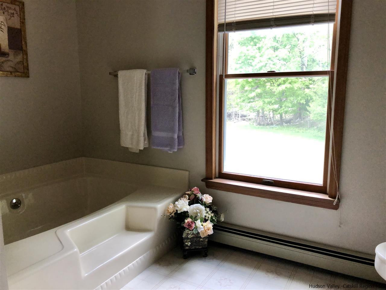 190 Buck Road Stone Ridge, NY 12484 - Photo 18 of 33 a bathroom with a bathtub and window
