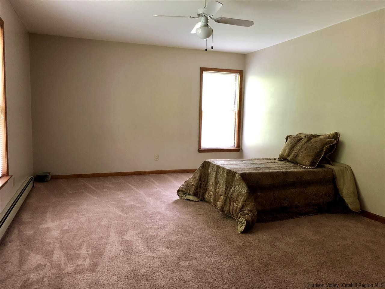 190 Buck Road Stone Ridge, NY 12484 - Photo 19 of 33 a bedroom with a bed and window