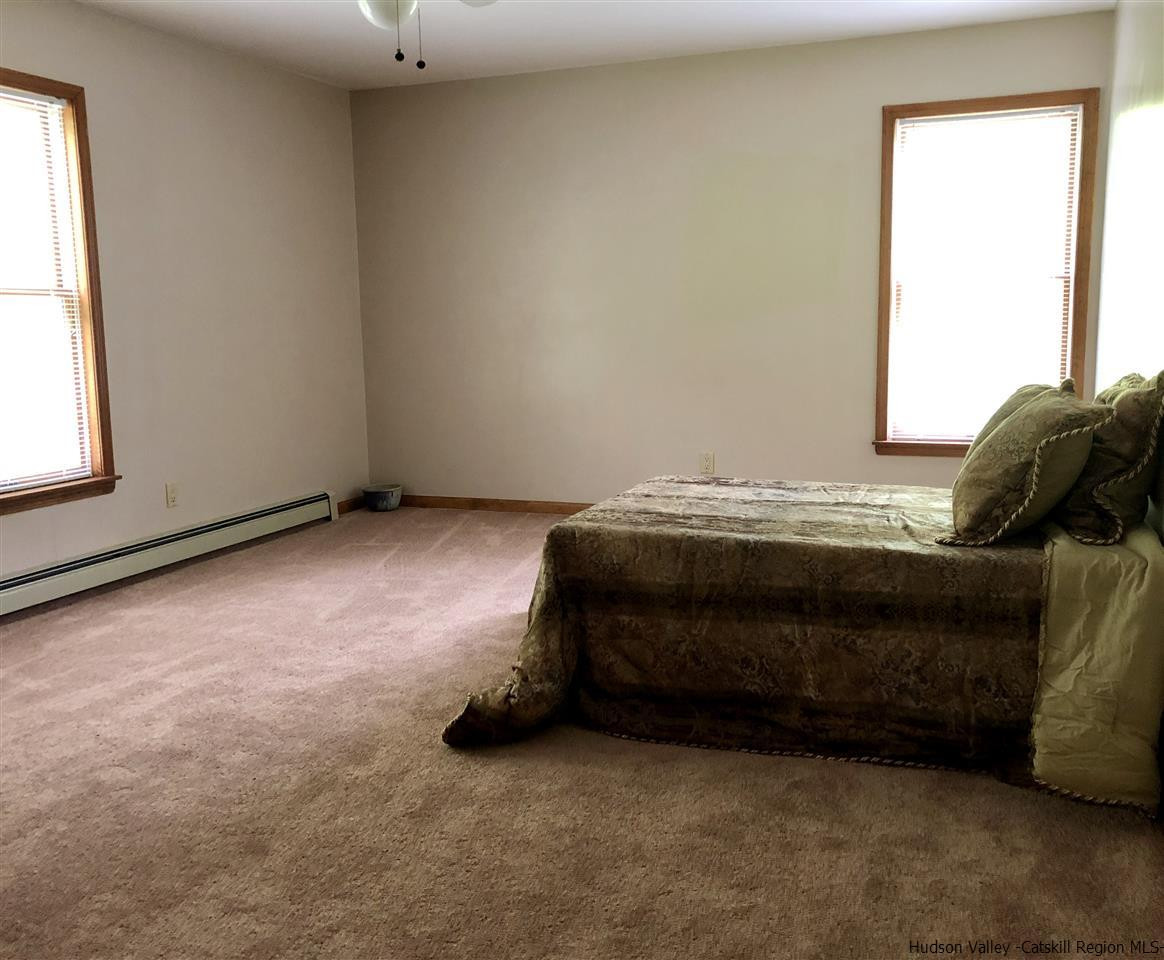 190 Buck Road Stone Ridge, NY 12484 - Photo 20 of 33 a bedroom with a bed and a window