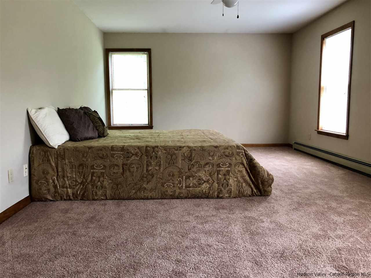 190 Buck Road Stone Ridge, NY 12484 - Photo 22 of 33 a bedroom with a bed and window