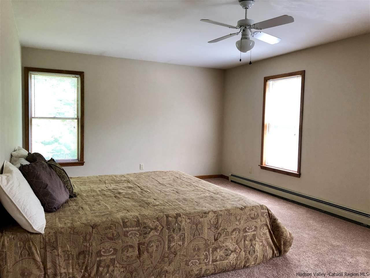 190 Buck Road Stone Ridge, NY 12484 - Photo 23 of 33 a bedroom with a bed and a window