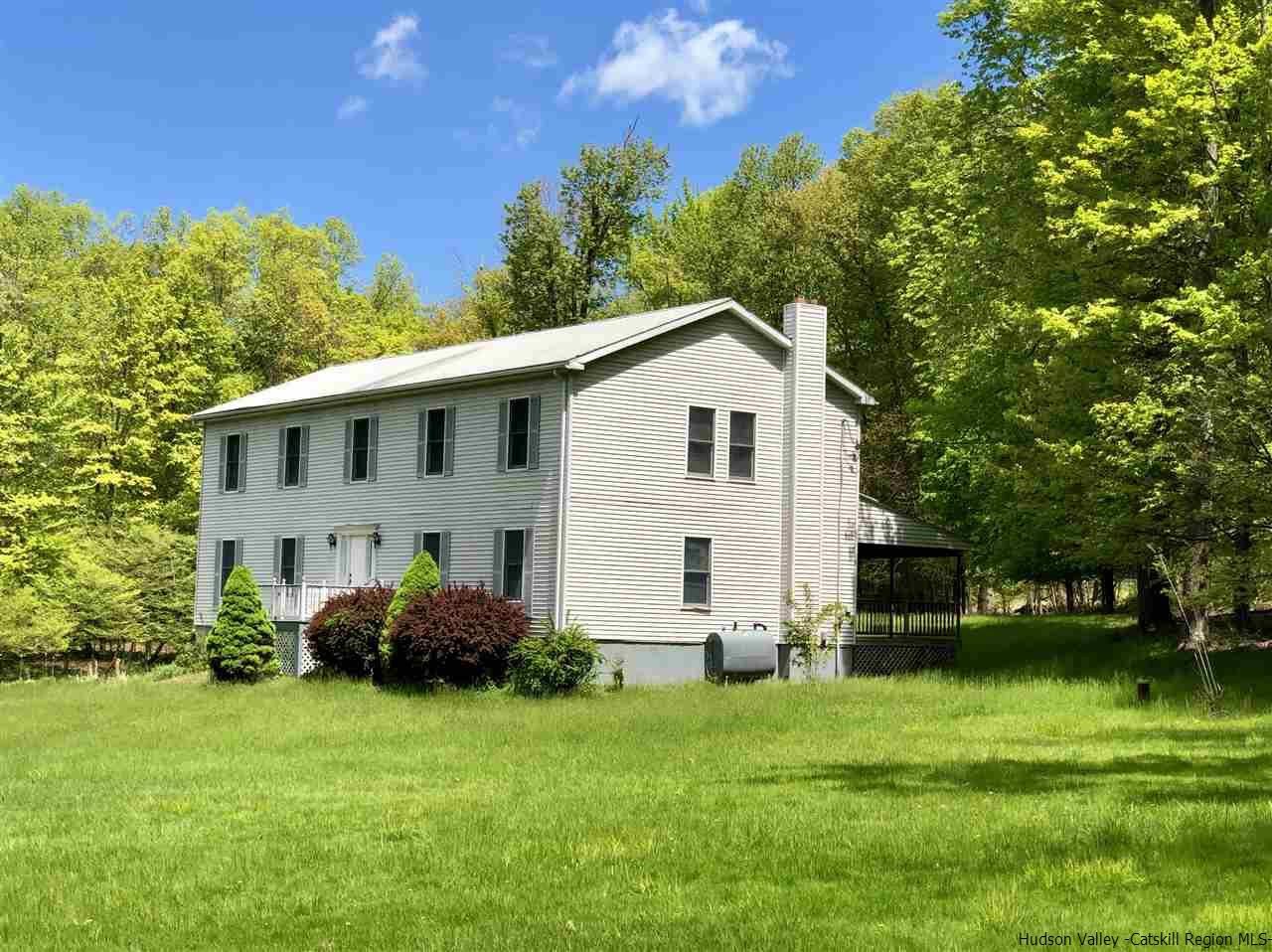 190 Buck Road Stone Ridge, NY 12484 - Photo 31 of 33 a view of a white house with a big yard and large trees
