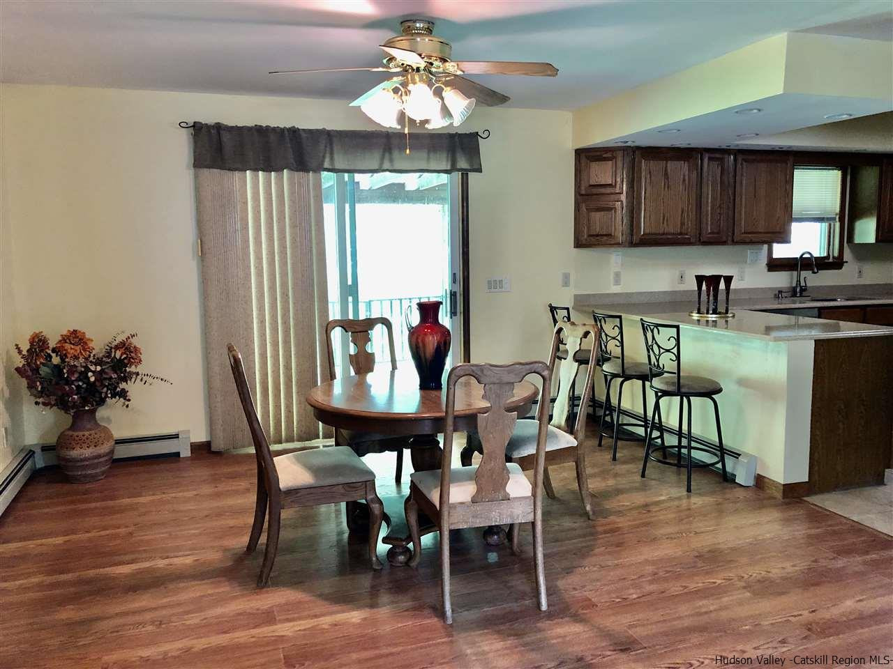 190 Buck Road Stone Ridge, NY 12484 - Photo 6 of 33 a view of a dining room with furniture and a chandelier