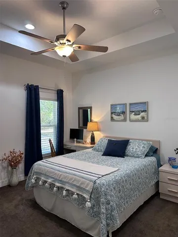 a bedroom with a large bed and a chandelier