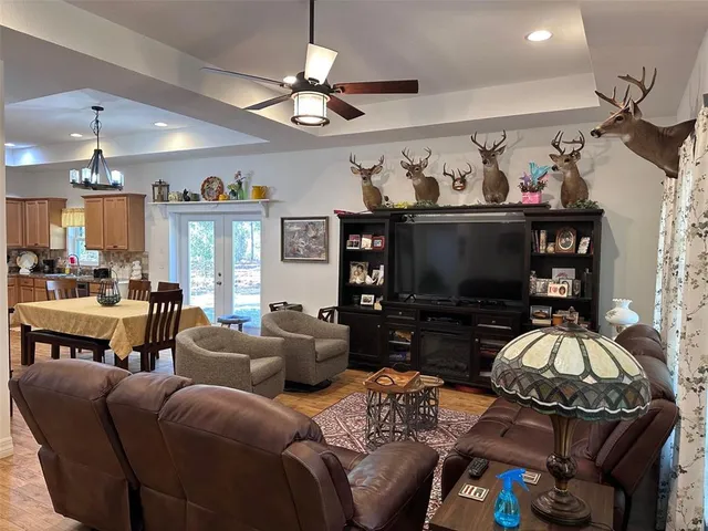 a living room with furniture a dining table and a fireplace