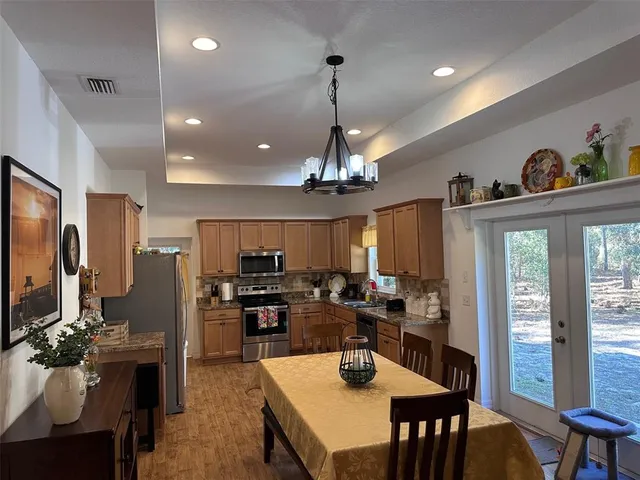 a view of a dining room and livingroom with furniture window and wooden floor
