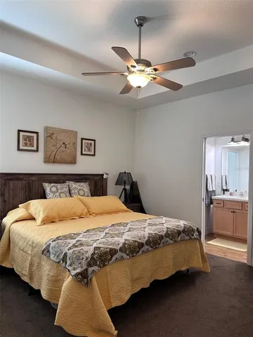 a bedroom with a bed and ceiling fan