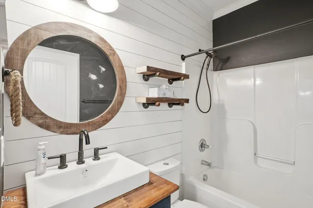 a view of a hallway with windows and chandelier