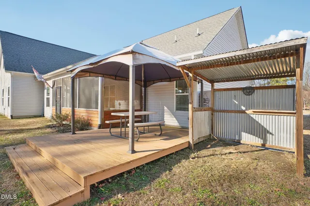 an aerial view of a house with a swimming pool and outdoor seating