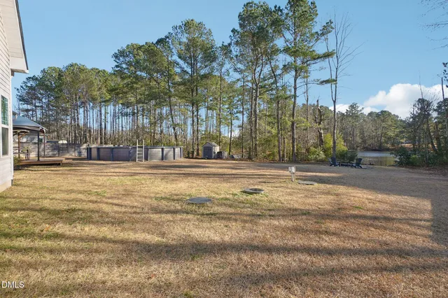 an aerial view of a swimming pool with outdoor seating